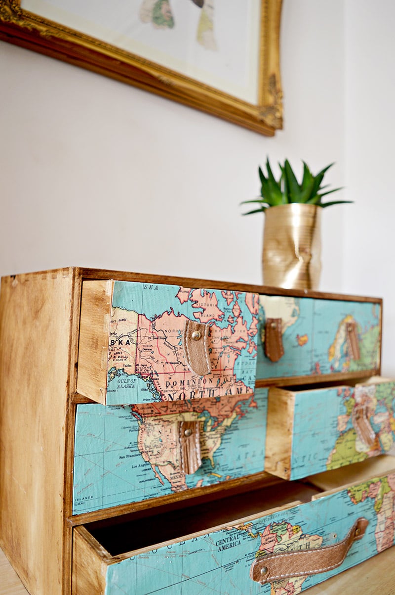 a dresser with a map attached to the drawers