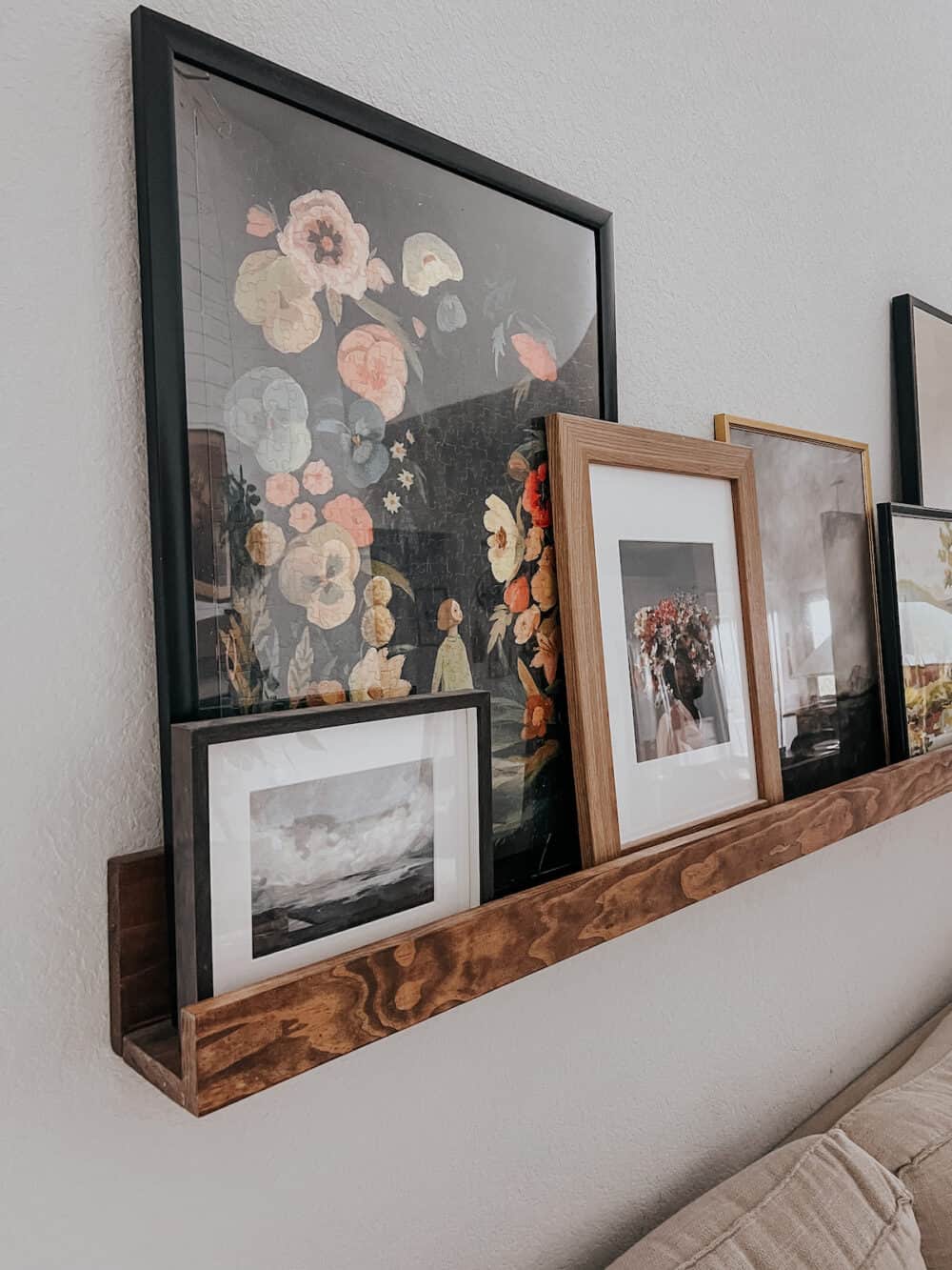 a floral puzzle framed and sitting on an art ledge 