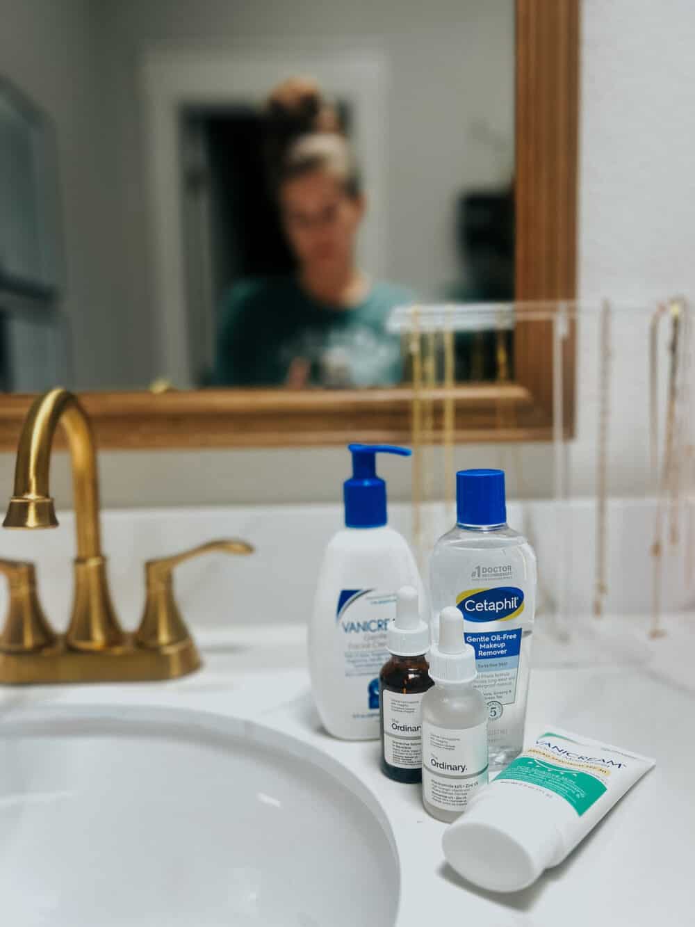 skincare products sitting on a bathroom counter 