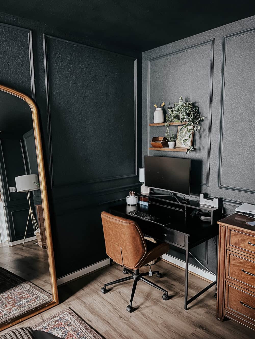 a corner bedroom office in a dark blue bedroom 
