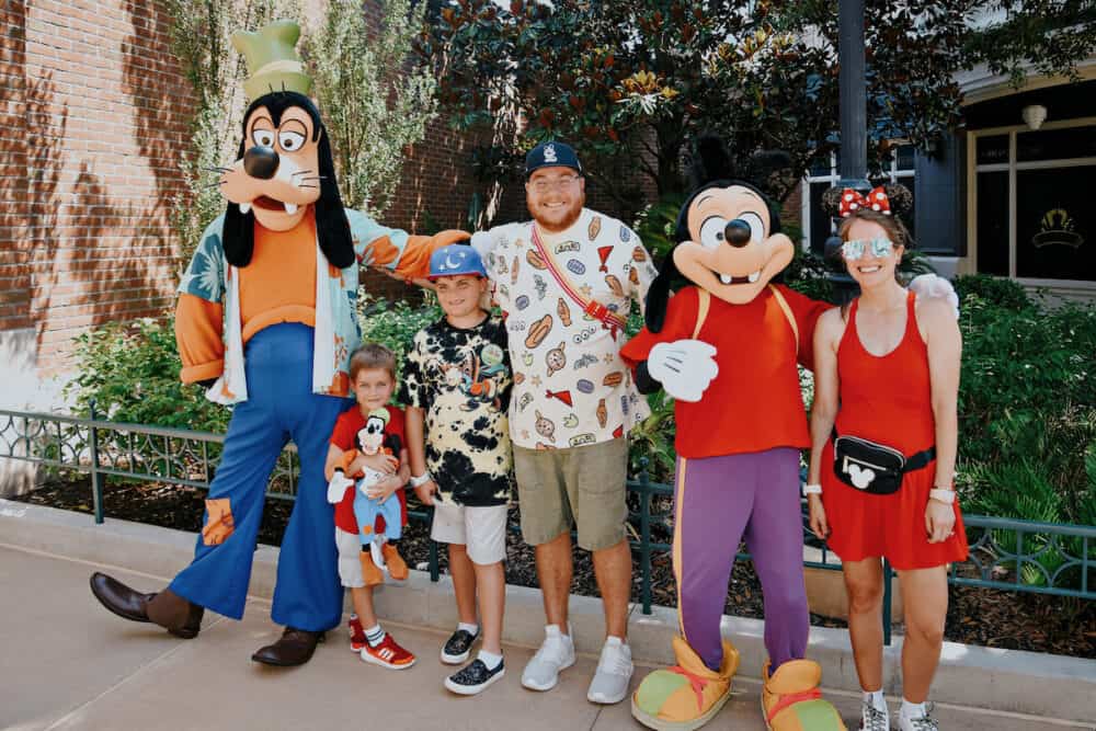 family posing with Goofy and Max in Hollywood Studios