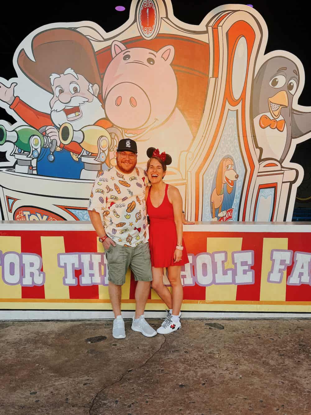 husband and wife posing in Toy Story Land at Hollywood Studios