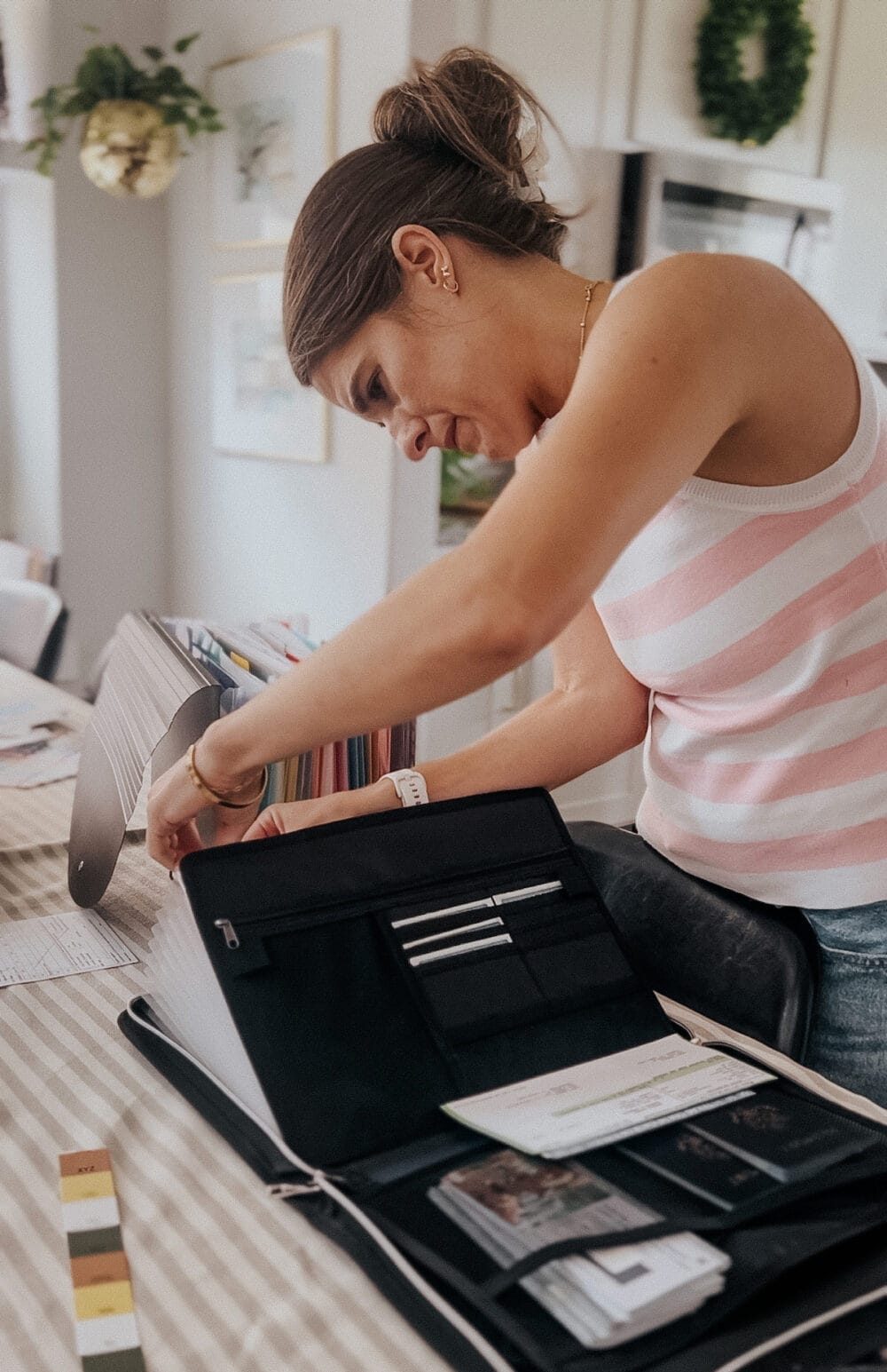 woman organizing paperwork in a document organizer 