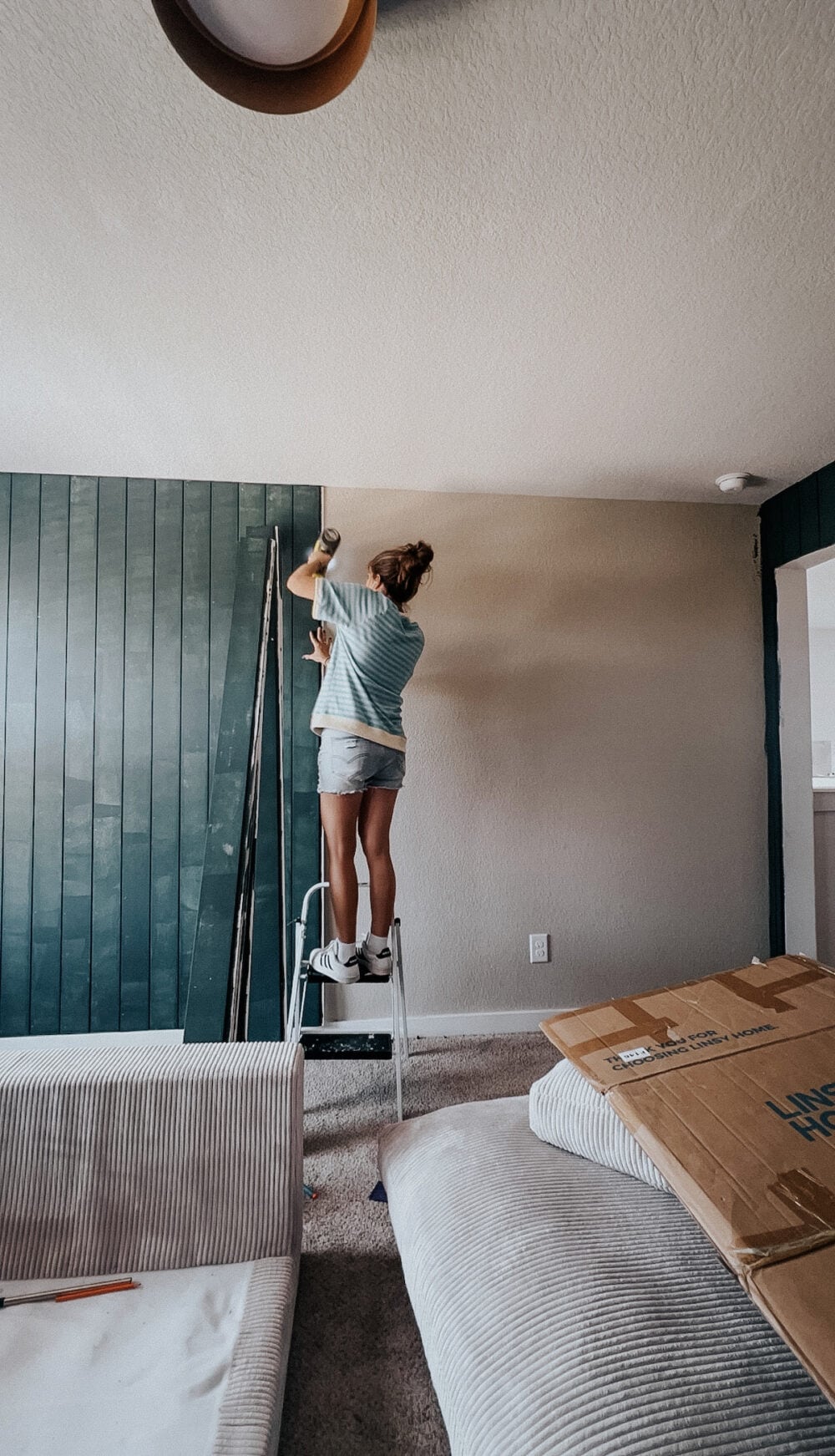 woman installing shiplap vertically