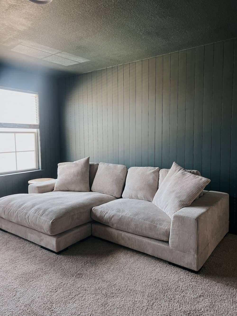 a bonus room with green shiplap and a green ceiling