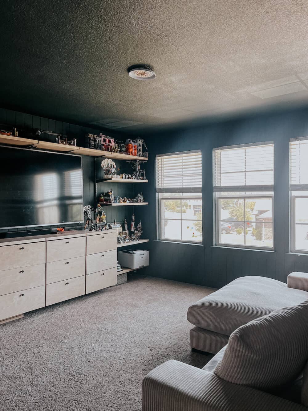 A family room with green shiplap and a green ceiling 