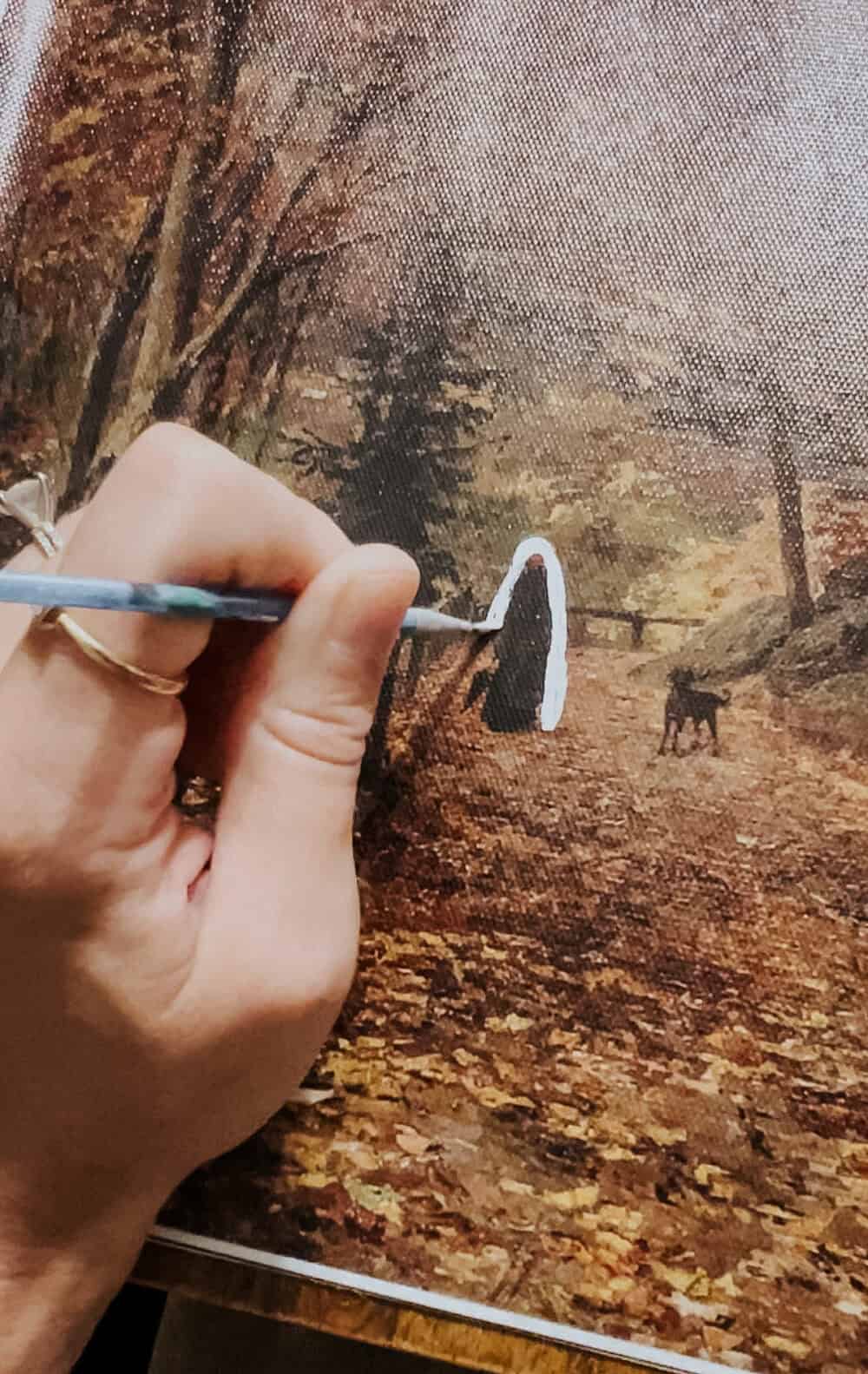 hand painting a ghost on a canvas print 