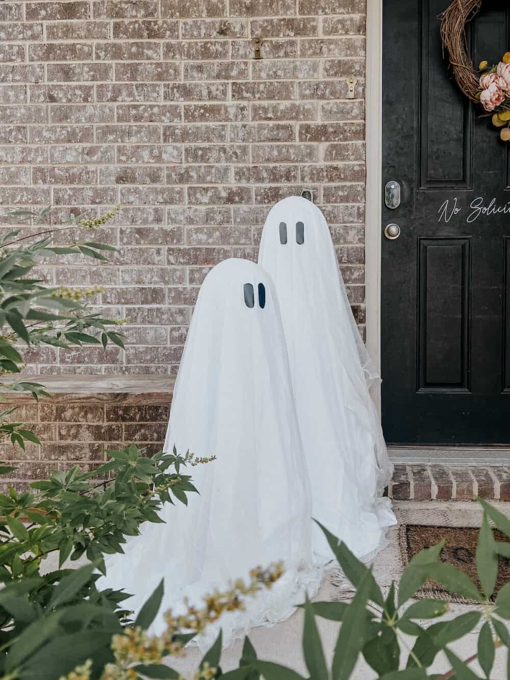 tomato cage ghosts on a small front porch