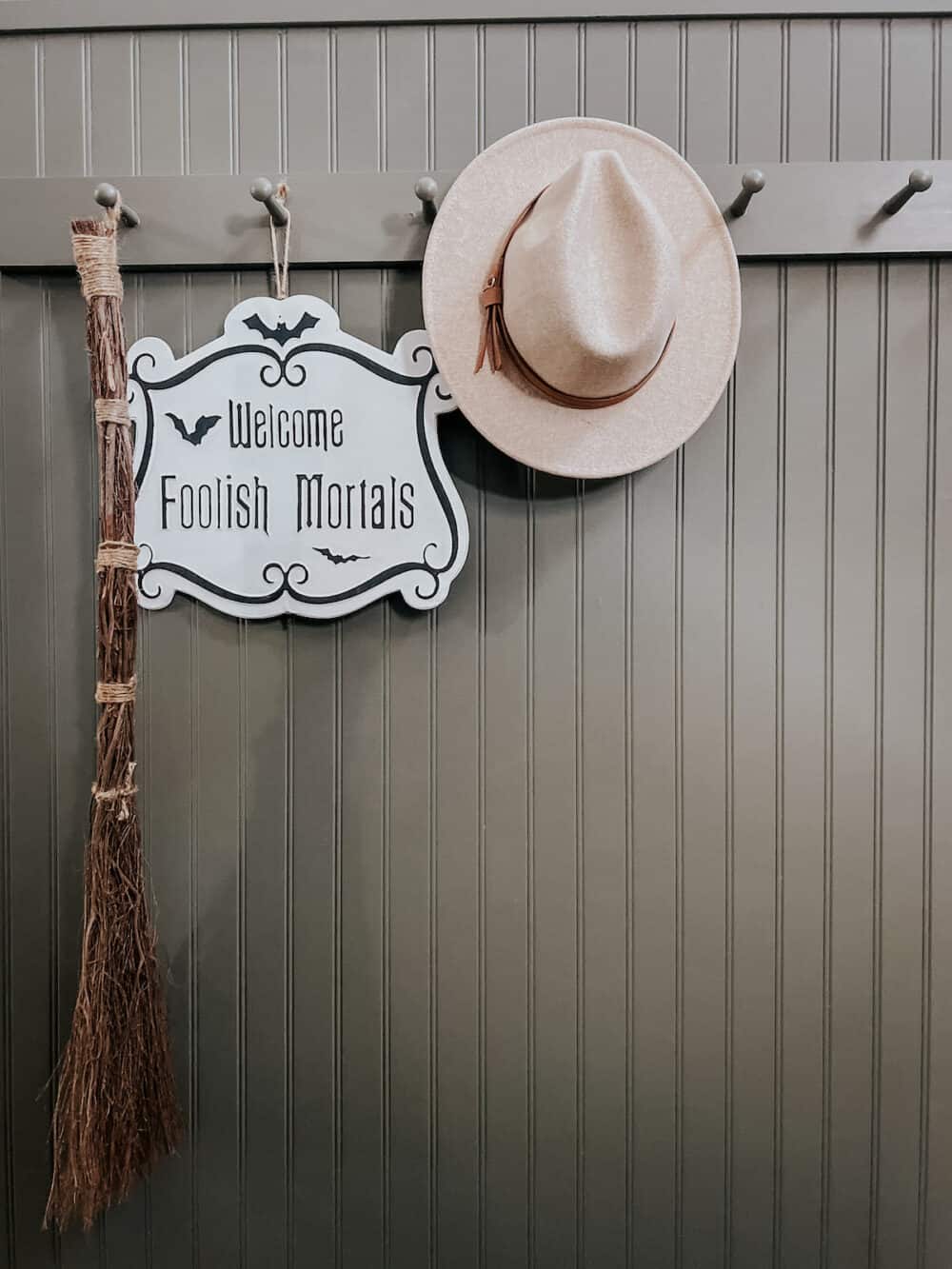 entryway peg board with halloween decor