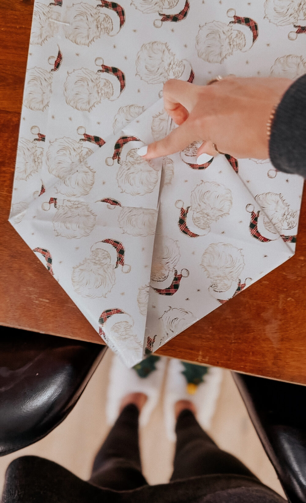 folding ends of wrapping paper in to create a gift bag